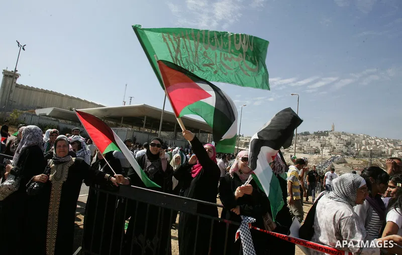 Palestinians wait for former prisoners to be released in East Jerusalem from Israeli prison, Tuesday, Oct. 18, 2011. Hamas agreed to release Israeli soldier Galit Schalit in exchange for 1,027 Palestinian prisoners, many...