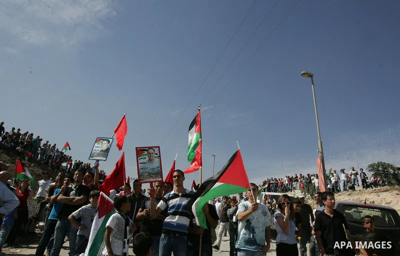 Palestinians wait for former prisoners to be released in East Jerusalem from Israeli prison, Tuesday, Oct. 18, 2011. Hamas agreed to release Israeli soldier Galit Schalit in exchange for 1,027 Palestinian prisoners, many...