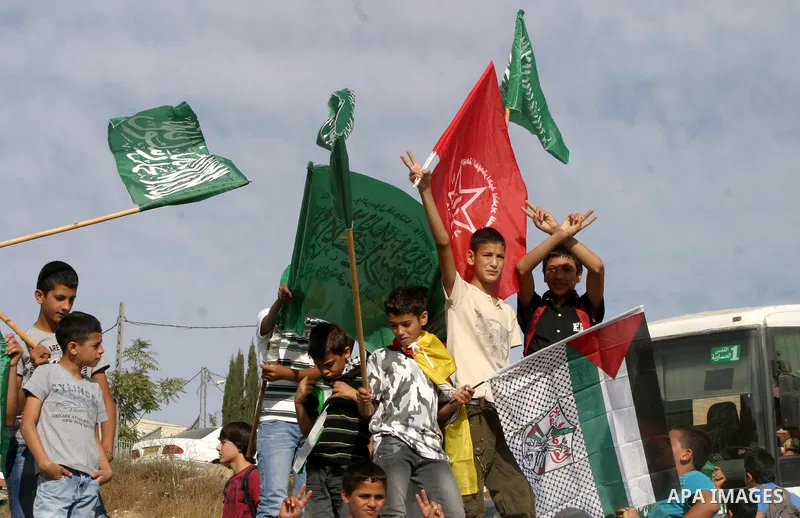 Palestinians wait for former prisoners to be released in East Jerusalem from Israeli prison, Tuesday, Oct. 18, 2011. Hamas agreed to release Israeli soldier Galit Schalit in exchange for 1,027 Palestinian prisoners, many...