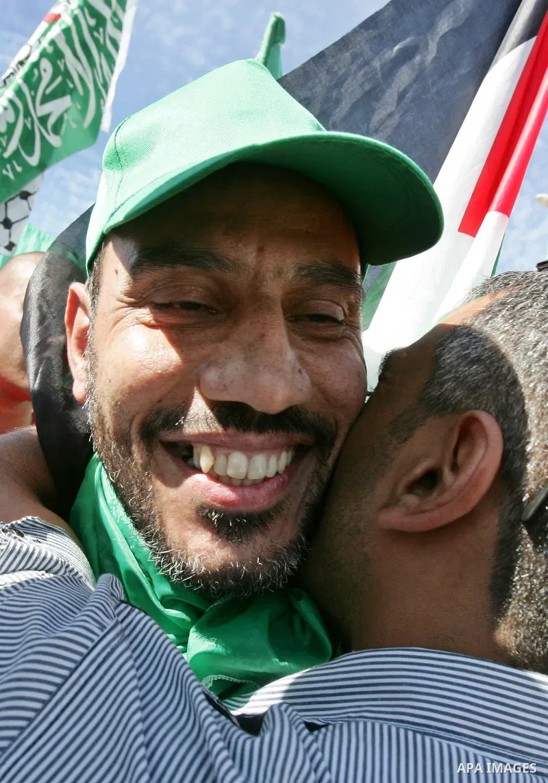 Newly released Palestinian prisoner Issam Shawish waves flags as he is carried by greeters in the Arab east Jerusalem neighbourhood of Ras al-Amud October 18, 2011. Israeli soldier Gilad Shalit and hundreds of Palestinia...
