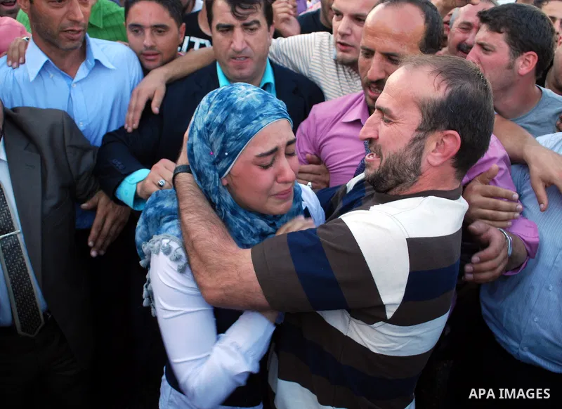 A Palestinian who was freed from an Israeli jail as part of a prisoners exchange deal hugs his daughter as he arrives to the West Bank city of Hebron on October 18, 2011. Israeli soldier Gilad Schalit and hundreds of Pal...