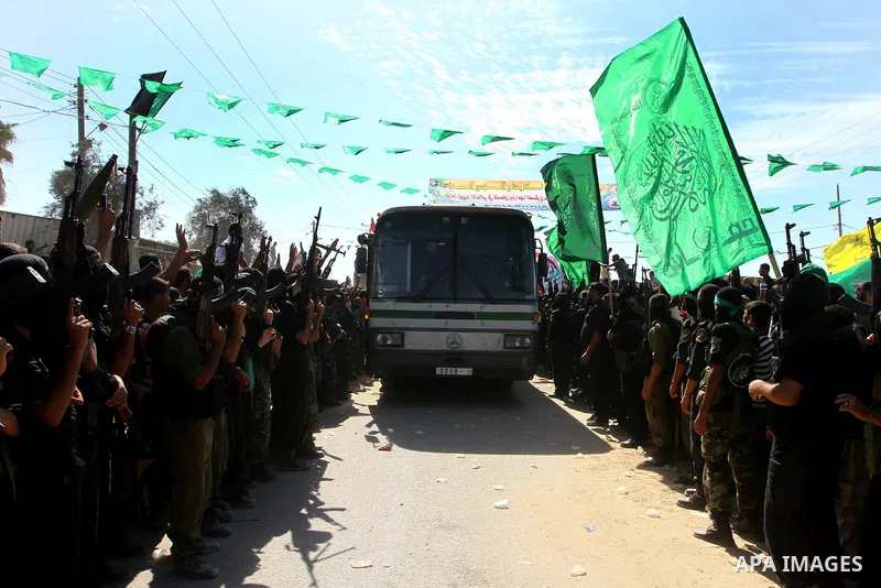 Hamas militants stand guard near Rafah Crossing through which Palestinian prisoners going to be freed in a prisoner swap between Hamas and Israel will enter the Gaza Strip on 18 October 2011 As Gilad Shalit, the Israeli...