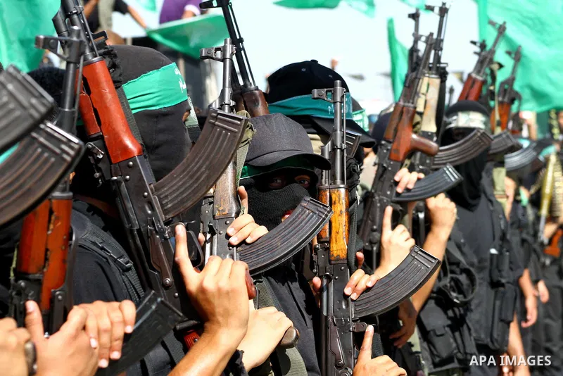 Hamas militants stand guard near Rafah Crossing through which Palestinian prisoners going to be freed in a prisoner swap between Hamas and Israel will enter the Gaza Strip on 18 October 2011 As Gilad Shalit, the Israeli...