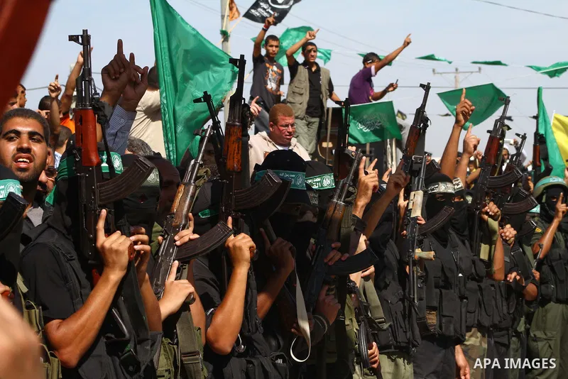 Hamas militants stand guard near Rafah Crossing through which Palestinian prisoners going to be freed in a prisoner swap between Hamas and Israel will enter the Gaza Strip on 18 October 2011 As Gilad Shalit, the Israeli...