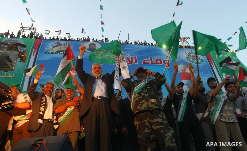 Palestinian Prime Minister in Gaza Strip, Ismail Haniyeh stands with released Palestinian prisoner among others as they celebrate during a welcoming ceremony, in Gaza City, Tuesday, Oct. 18, 2011. Hamas agreed to release...