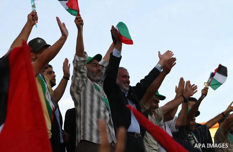 Palestinian Prime Minister in Gaza Strip, Ismail Haniyeh stands with released Palestinian prisoner among others as they celebrate during a welcoming ceremony, in Gaza City, Tuesday, Oct. 18, 2011. Hamas agreed to release...