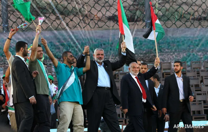 Palestinian Prime Minister in Gaza Strip, Ismail Haniyeh stands with released Palestinian prisoner among others as they celebrate during a welcoming ceremony, in Gaza City, Tuesday, Oct. 18, 2011. Hamas agreed to release...