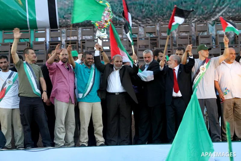 Palestinian Prime Minister in Gaza Strip, Ismail Haniyeh stands with released Palestinian prisoner among others as they celebrate during a welcoming ceremony, in Gaza City, Tuesday, Oct. 18, 2011. Hamas agreed to release...