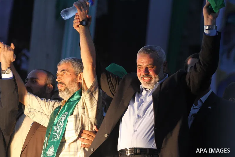 Palestinian Prime Minister in Gaza Strip, Ismail Haniyeh stands with released Palestinian prisoner among others as they celebrate during a welcoming ceremony, in Gaza City, Tuesday, Oct. 18, 2011. Hamas agreed to release...