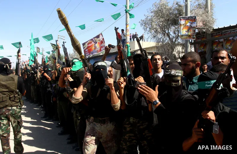 Hamas militants stand guard near Rafah Crossing through which Palestinian prisoners going to be freed in a prisoner swap between Hamas and Israel will enter the Gaza Strip on 18 October 2011 As Gilad Shalit, the Israeli...
