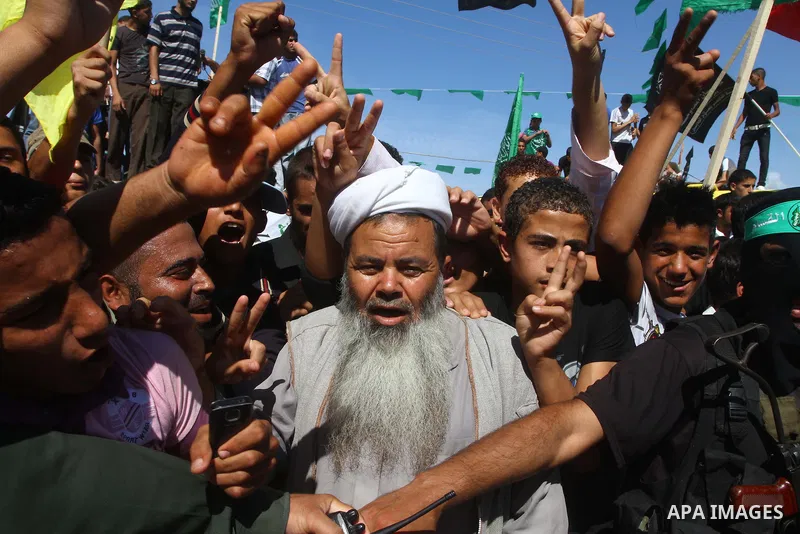 Palestinians celebrate near Rafah Crossing through which Palestinian prisoners going to be freed in a prisoner swap between Hamas and Israel will enter the Gaza Strip on 18 October 2011 As Gilad Shalit, the Israeli soldi...