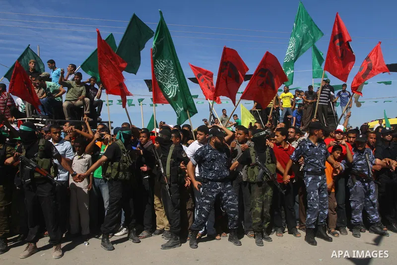 Hamas militants stand guard near Rafah Crossing through which Palestinian prisoners going to be freed in a prisoner swap between Hamas and Israel will enter the Gaza Strip on 18 October 2011 As Gilad Shalit, the Israeli...