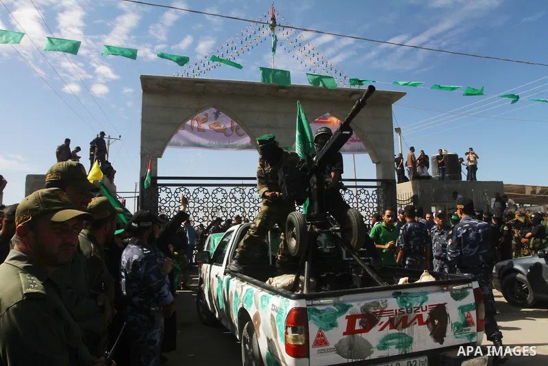 Hamas militants stand guard near Rafah Crossing through which Palestinian prisoners going to be freed in a prisoner swap between Hamas and Israel will enter the Gaza Strip on 18 October 2011 As Gilad Shalit, the Israeli...