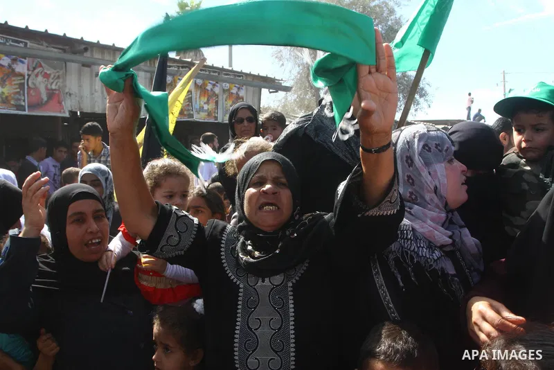 Palestinians celebrate near Rafah Crossing through which Palestinian prisoners going to be freed in a prisoner swap between Hamas and Israel will enter the Gaza Strip on 18 October 2011 As Gilad Shalit, the Israeli soldi...