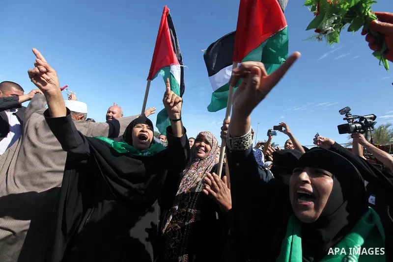 Palestinian prisoners cross to the southern Gaza Strip from the Egyptian side of the Rafah border on Oct. 18, 2011 upon their release from Israeli prisons under a landmark deal to free abducted Israeli soldier Gilad Shal...