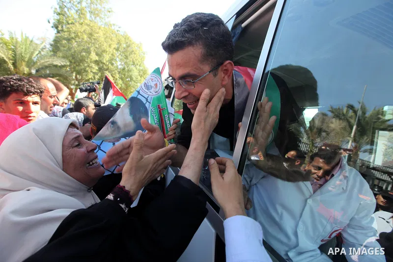 Palestinians greet their relative released Palestinian prisoner at the Rafah border crossing in southern Gaza Strip, Tuesday, Oct. 18, 2011. The Hamas militant group released an Israeli soldier Tuesday more than five yea...
