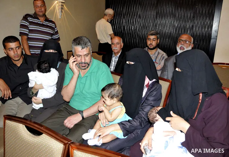 A Palestinian prisoner who will be deported to Turkey, gathers with his family during a press conference in Cairo, Egypt, 18 October 2011. According to media sources, Hamas on 18 October exchanged Gilad Shalit, the Israe...