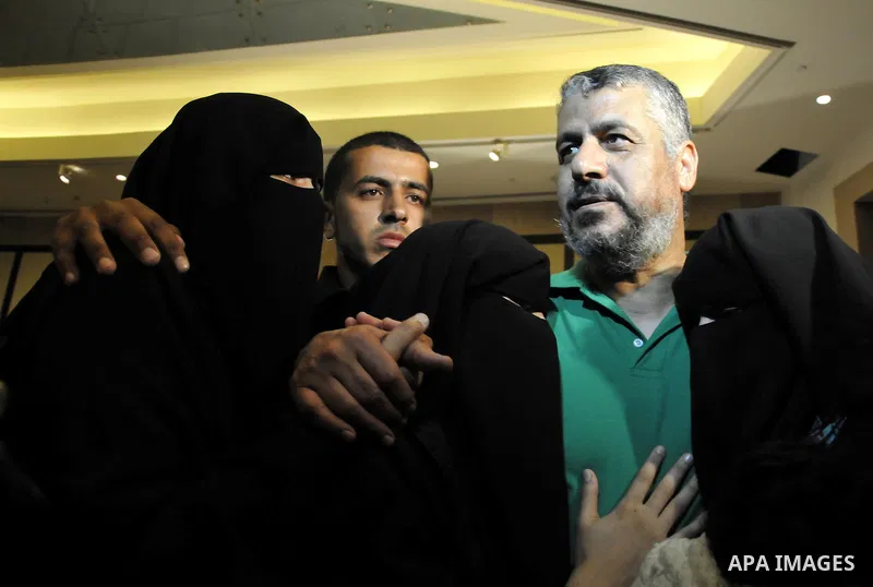 A Palestinian prisoner (R) who will be deported to Turkey, gathers with his family during a press conference in Cairo, Egypt, 18 October 2011. According to media sources, Hamas on 18 October exchanged Gilad Shalit, the I...