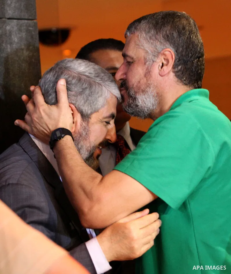 Exiled Palestinian Hamas leader Khaled Meshaal meets with some 40 Palestinian prisoners who were freed by Israel but are to be deported overseas, in Cairo on October 18, 2011. Israeli soldier Gilad Shalit was released in...