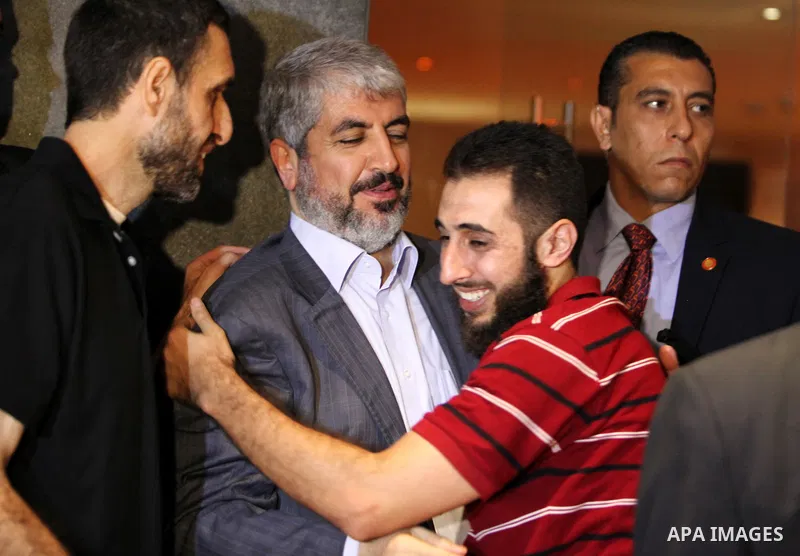 Exiled Palestinian Hamas leader Khaled Meshaal meets with some 40 Palestinian prisoners who were freed by Israel but are to be deported overseas, in Cairo on October 18, 2011. Israeli soldier Gilad Shalit was released in...