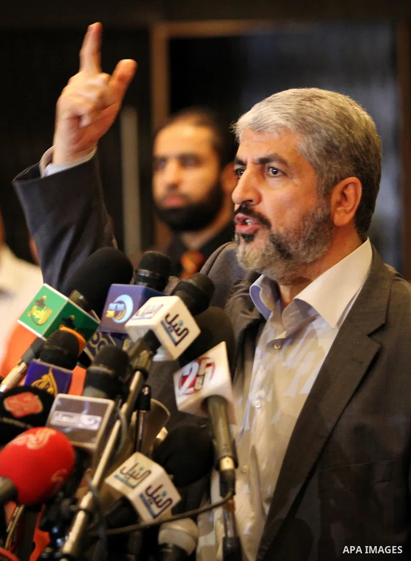 Exiled Palestinian Hamas leader Khaled Meshaal addresses a meeting with some 40 Palestinian prisoners who were freed by Israel but are to be deported overseas, in Cairo on October 18, 2011. Israeli soldier Gilad Shalit w...