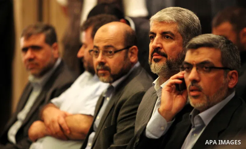 Exiled Palestinian Hamas leader Khaled Meshaal meets with some 40 Palestinian prisoners who were freed by Israel but are to be deported overseas, in Cairo on October 18, 2011. Israeli soldier Gilad Shalit was released in...
