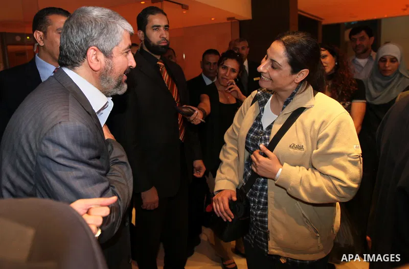 Exiled Palestinian Hamas leader Khaled Meshaal meets with some 40 Palestinian prisoners who were freed by Israel but are to be deported overseas, in Cairo on October 18, 2011. Israeli soldier Gilad Shalit was released in...