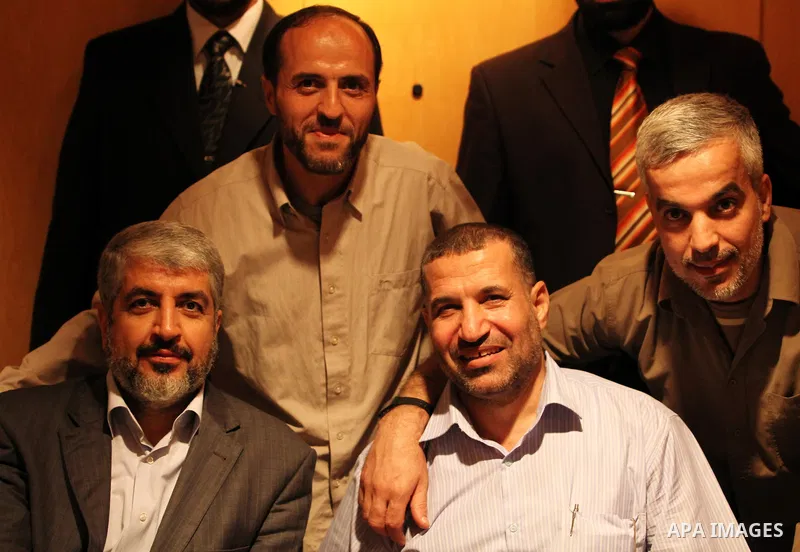 Exiled Palestinian Hamas leader Khaled Meshaal meets with Hamas militant leader Ahmed al-Jabari, in Cairo on October 18, 2011. Israeli soldier Gilad Shalit was released in a landmark deal which also saw 477 Palestinian d...