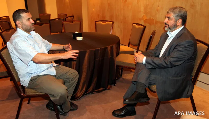 Exiled Palestinian Hamas leader Khaled Meshaal meets with Hamas militant leader Ahmed al-Jabari, in Cairo on October 18, 2011. Israeli soldier Gilad Shalit was released in a landmark deal which also saw 477 Palestinian d...