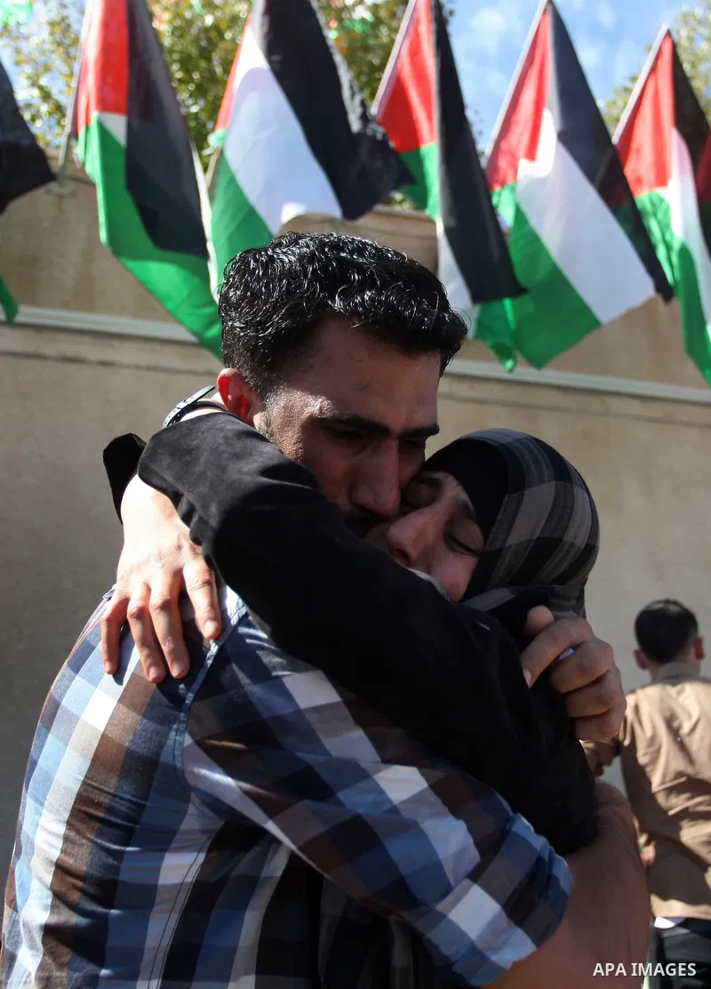 Palestinian prisoners are welcomed by a crowd following the release of hundreds of prisoners from Israeli jails on October 18,2011 at the Palestinian Authority headquarters in the West Bank city of Ramallah. Crowds of Pa...