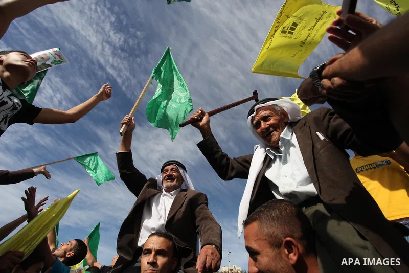 Palestinian prisoners are welcomed by a crowd following the release of hundreds of prisoners from Israeli jails on October 18,2011 at the Palestinian Authority headquarters in the West Bank city of Ramallah. Crowds of Pa...