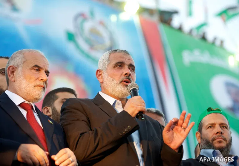 Palestinian Prime Minister in Gaza Strip, Ismail Haniyeh stands with released Palestinian prisoner among others as they celebrate during a welcoming ceremony, in Gaza City, Tuesday, Oct. 18, 2011. Hamas agreed to release...