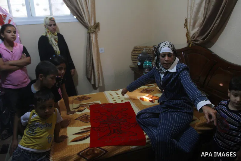 Freed Palestinian prisoner Wafa Albes sits with her relatives after her release from an Israeli jail on October 19, 2011 in the Jabalia refugee camp. Wafa has been jailed in Israel since 2005. The Palestinian Hamas movem...