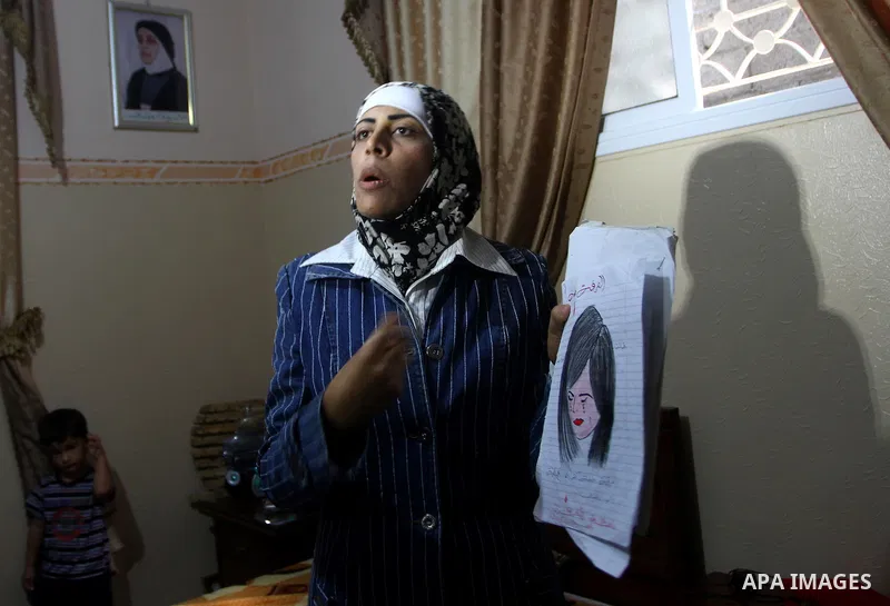 Freed Palestinian prisoner Wafa Albes displays her drawings for her relatives after her release from an Israeli jail on October 19, 2011 in the Jabalia refugee camp. Wafa has been jailed in Israel since 2005. The Palesti...