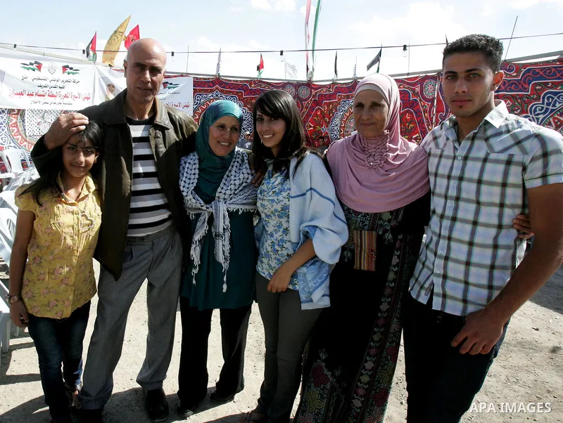 Freed Palestinian prisoner Ibtisam Esawi is greeted by relatives and friends after her release from an Israeli jail in the East Jerusalem neighbourhood of Jabal al-Mukaber on October 19, 2011. The Palestinian Hamas movem...