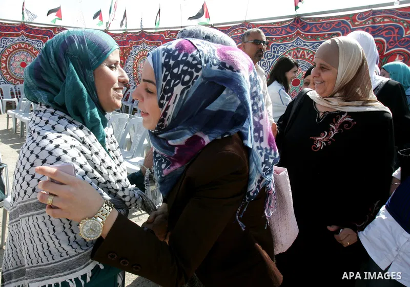 Freed Palestinian prisoner Ibtisam Esawi is greeted by relatives and friends after her release from an Israeli jail in the East Jerusalem neighbourhood of Jabal al-Mukaber on October 19, 2011. The Palestinian Hamas movem...