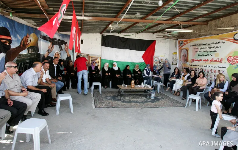 Freed Palestinian prisoner Ibtisam Esawi is greeted by relatives and friends after her release from an Israeli jail in the East Jerusalem neighbourhood of Jabal al-Mukaber on October 19, 2011. The Palestinian Hamas movem...