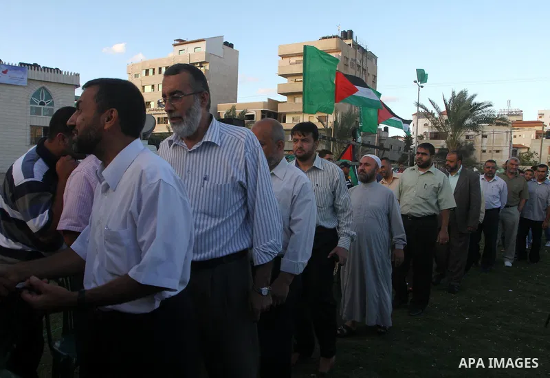 Palestinians shake hands as they visit the tent erected to welcome Palestinian prisoners released in exchange for the captured Israeli soldier Gilad Schalit in Gaza City, Wednesday, Oct. 19, 2011. Photo by Ashraf Amra