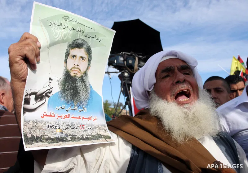 Palestinians wait at the Beituniya checkpoint for released Palestinian prisoners to cross into the West Bank city of Ramallah, Tuesday, Oct. 18, 2011. The Hamas militant group released an Israeli soldier Tuesday more tha...