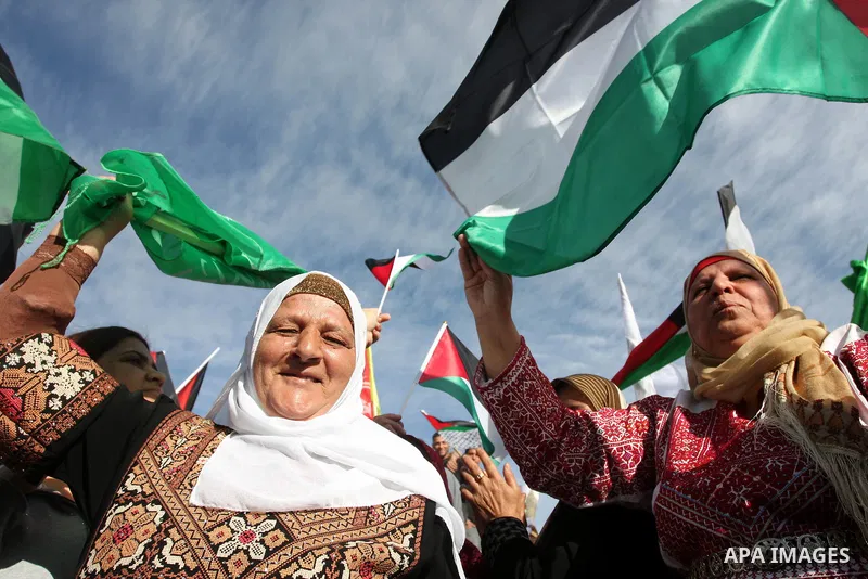 Palestinians wait at the Beituniya checkpoint for released Palestinian prisoners to cross into the West Bank city of Ramallah, Tuesday, Oct. 18, 2011. The Hamas militant group released an Israeli soldier Tuesday more tha...