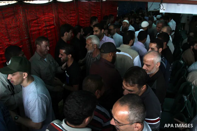 Palestinians shake hands as they visit the tent erected to welcome Palestinian prisoners released in exchange for the captured Israeli soldier Gilad Schalit in Gaza City, Wednesday, Oct. 19, 2011. Photo by Mohammed Asad