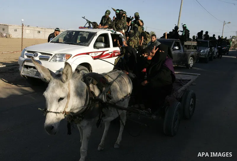 Hamas militants visit a freed Palestinian prisoner in Rafah in southern Gaza Strip October 19, 2011. Palestinians freed by Israel in a trade for soldier Gilad Shalit took their morning exercise on Wednesday around a luxu...