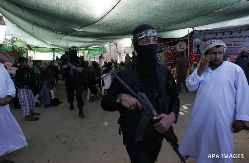 Hamas militants visit a freed Palestinian prisoner in Rafah in southern Gaza Strip October 19, 2011. Palestinians freed by Israel in a trade for soldier Gilad Shalit took their morning exercise on Wednesday around a luxu...