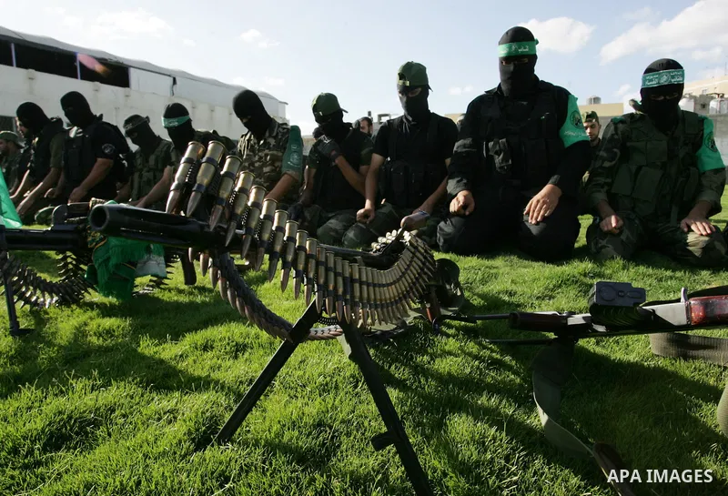 Hamas militants pray before going to pay their respects to freed Palestinian prisoners in Rafah, southern Gaza Strip, Wednesday, Oct. 19, 2011. Tens of thousands of flag-waving Palestinians celebrated the homecoming of h...