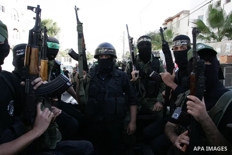 Hamas militants pray before going to pay their respects to freed Palestinian prisoners in Rafah, southern Gaza Strip, Wednesday, Oct. 19, 2011. Tens of thousands of flag-waving Palestinians celebrated the homecoming of h...