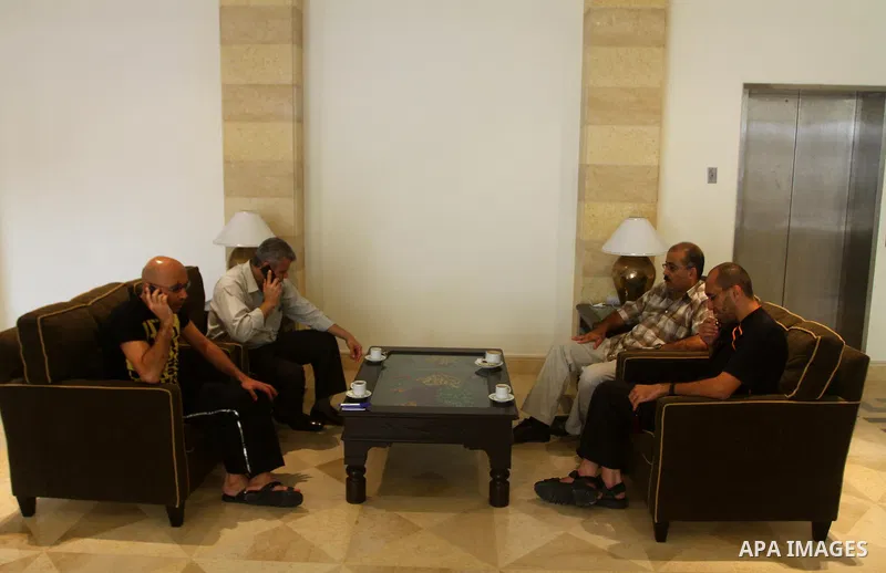 Freed Palestinian prisoners sit in the cafe of Al-Mashtal hotel, where they staying, in the Gaza Strip October 20, 2011. Israeli soldier Gilad Shalit and hundreds of Palestinians crossed Israel's borders in opposite dire...