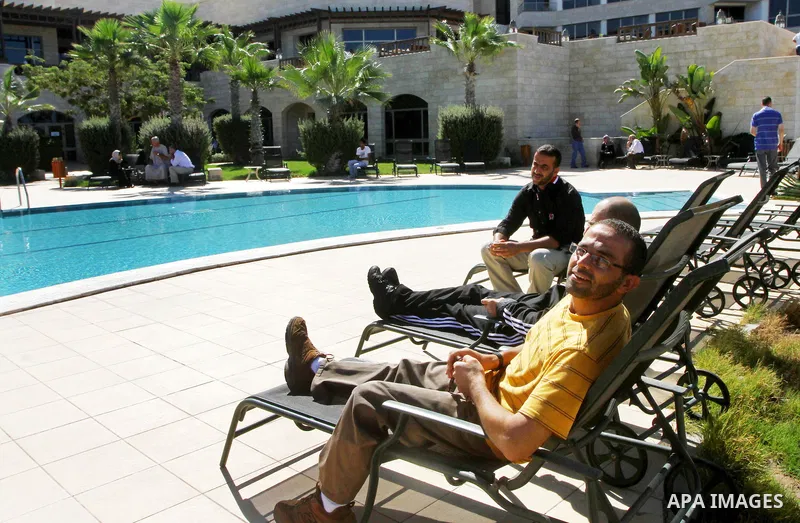 A freed Palestinian prisoner sits near a swimming pool at Al-Mashtal hotel, where he and other former prisoners are currently staying, in the Gaza Strip Oct. 20, 2011. Israeli soldier Gilad Shalit and hundreds of Palesti...
