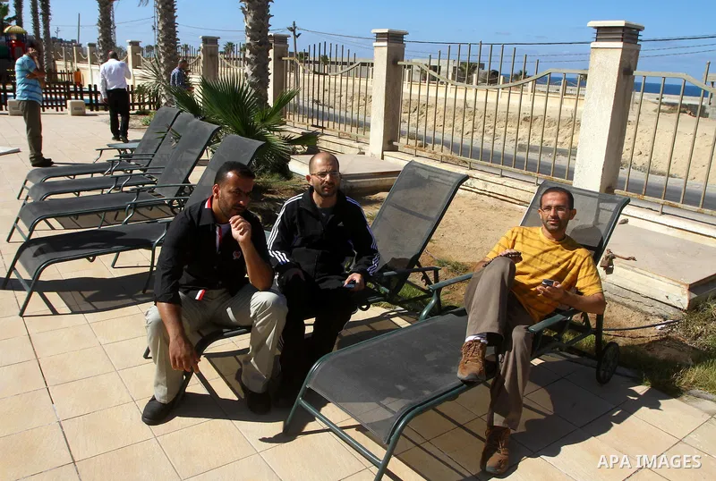 A freed Palestinian prisoner sits near a swimming pool at Al-Mashtal hotel, where he and other former prisoners are currently staying, in the Gaza Strip Oct. 20, 2011. Israeli soldier Gilad Shalit and hundreds of Palesti...