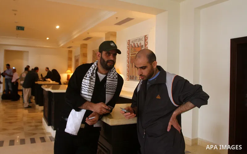 Freed Palestinian prisoners sit in the cafe of Al-Mashtal hotel, where they staying, in the Gaza Strip October 20, 2011. Israeli soldier Gilad Shalit and hundreds of Palestinians crossed Israel's borders in opposite dire...
