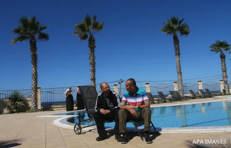 A freed Palestinian prisoner sits near a swimming pool at Al-Mashtal hotel, where he and other former prisoners are currently staying, in the Gaza Strip Oct. 20, 2011. Israeli soldier Gilad Shalit and hundreds of Palesti...